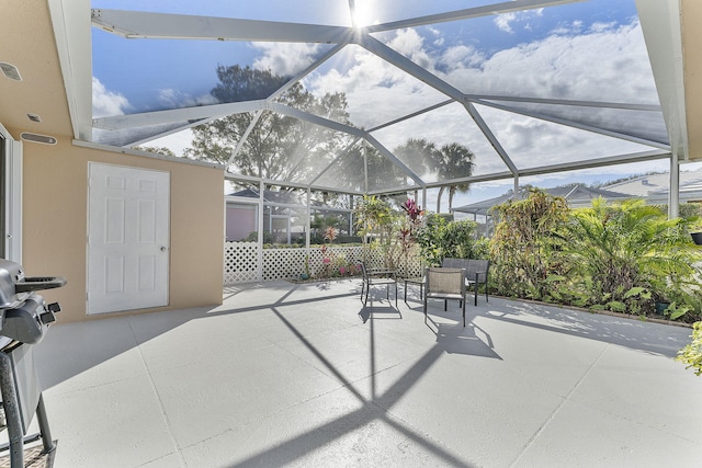 view of patio with glass enclosure