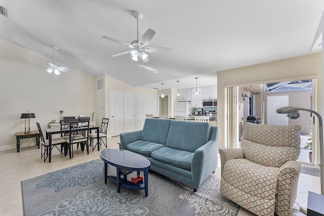 living room with ceiling fan and vaulted ceiling