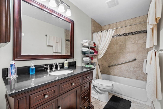 full bathroom with tile patterned flooring, shower / bath combo with shower curtain, vanity, and toilet