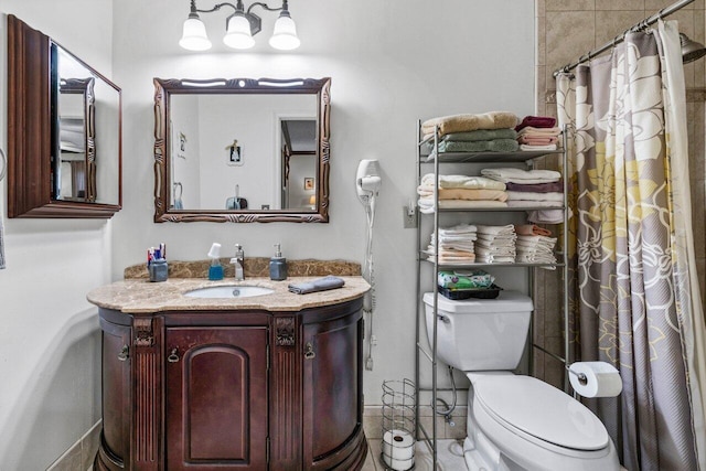 bathroom with toilet, walk in shower, and vanity