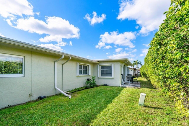 rear view of house featuring a yard