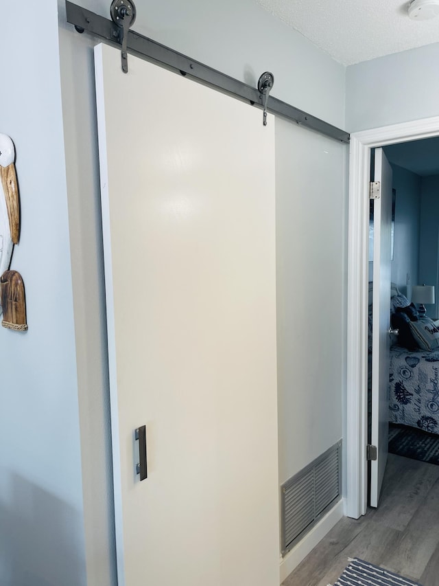 bathroom featuring a textured ceiling and hardwood / wood-style flooring