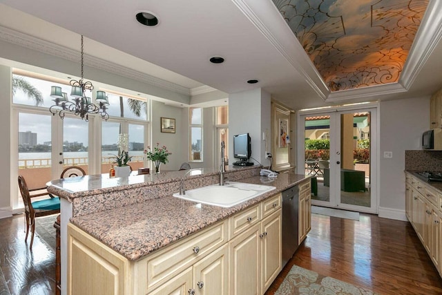 kitchen featuring sink, french doors, cream cabinets, and a raised ceiling