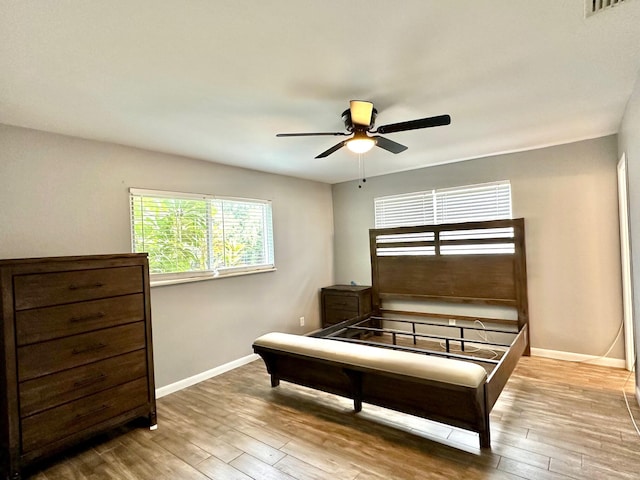 bedroom with ceiling fan and wood-type flooring