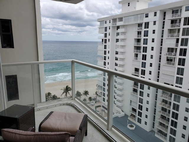 balcony featuring a beach view and a water view