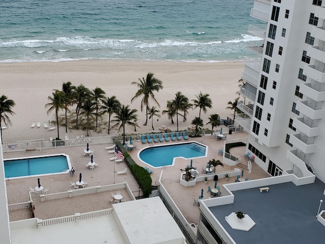 view of pool with a beach view and a water view