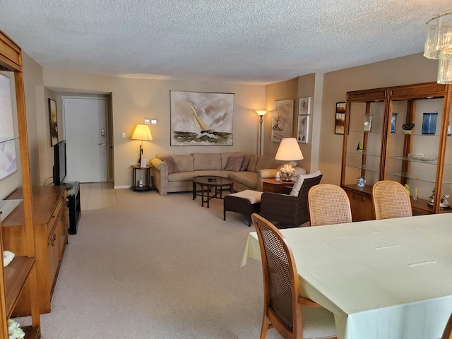 living room with a textured ceiling and light colored carpet