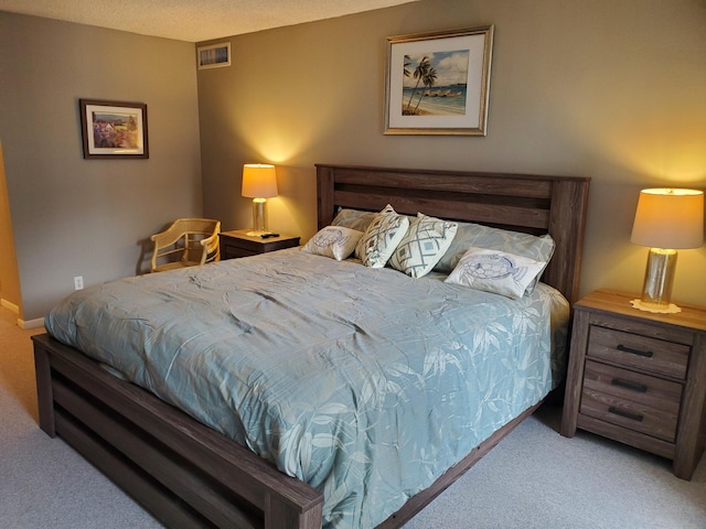 carpeted bedroom featuring a textured ceiling