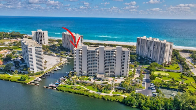 drone / aerial view featuring a water view and a view of the beach