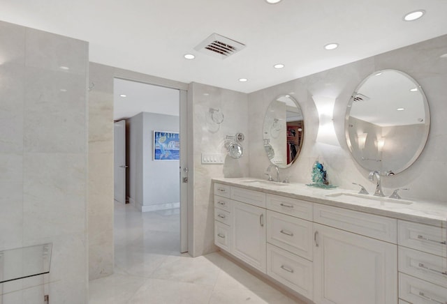 bathroom featuring tile walls and vanity