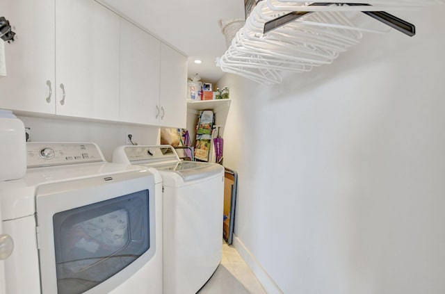 washroom featuring independent washer and dryer and cabinets