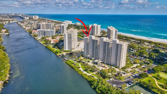 drone / aerial view with a beach view and a water view