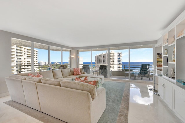 living room featuring a wall of windows and a water view