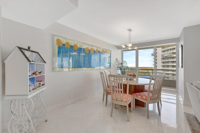 dining room with light tile patterned floors and a notable chandelier