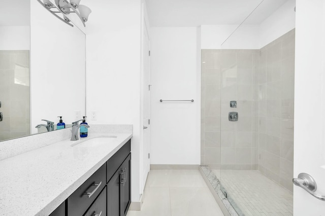 bathroom with vanity, tile patterned floors, and a tile shower