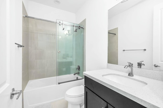 full bathroom with bath / shower combo with glass door, toilet, and vanity