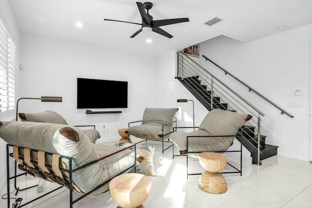 living room with ceiling fan and light tile patterned flooring