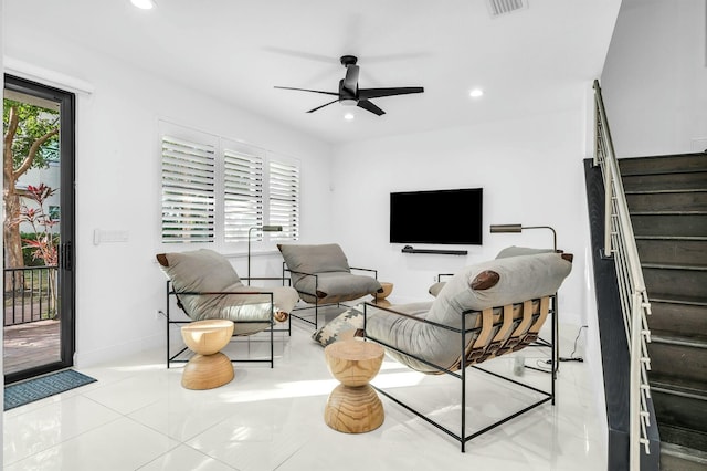 living room with ceiling fan and light tile patterned floors