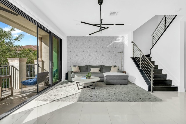 living room with an inviting chandelier and tile patterned floors