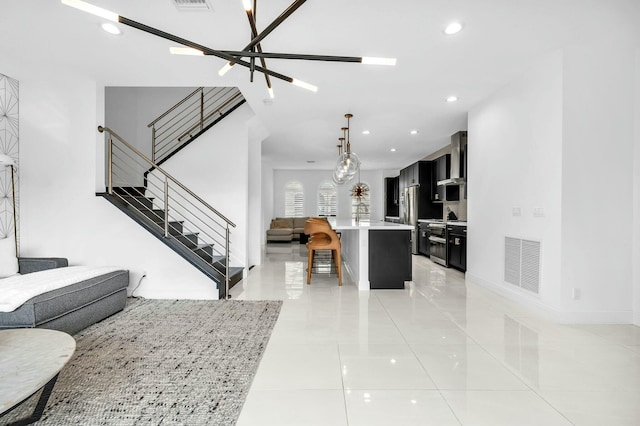 living room featuring light tile patterned floors and a notable chandelier