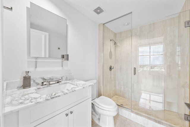 bathroom with a shower with door, toilet, and vanity