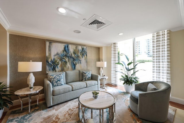 living room with crown molding and hardwood / wood-style flooring