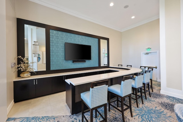 bar featuring light tile patterned flooring and crown molding