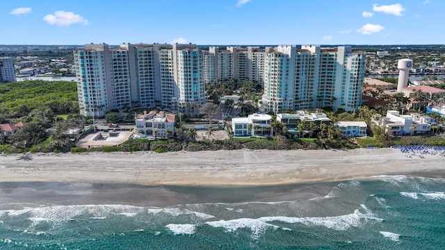 birds eye view of property with a water view and a view of the beach