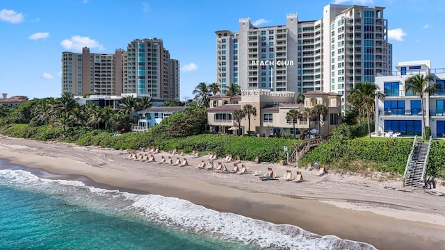 exterior space with a water view and a view of the beach