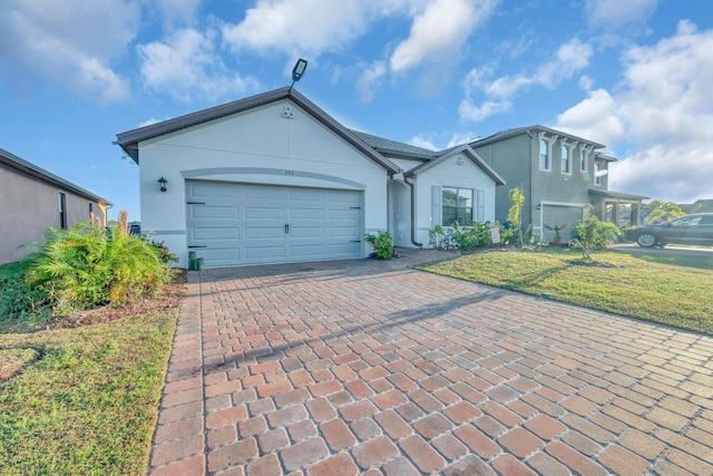 single story home featuring a front lawn and a garage