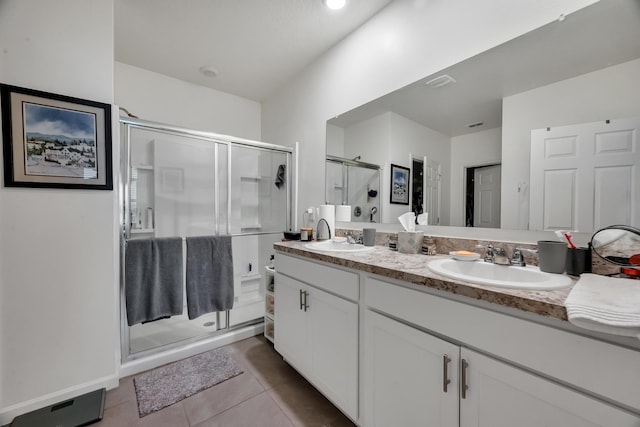 bathroom featuring walk in shower, vanity, tile patterned floors, and toilet