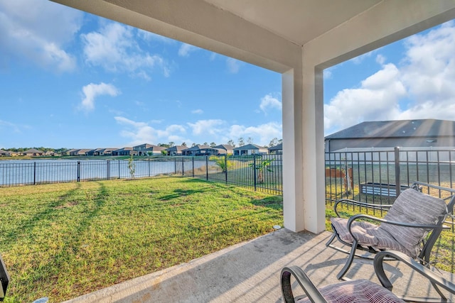 exterior space featuring a yard, a water view, and a patio area