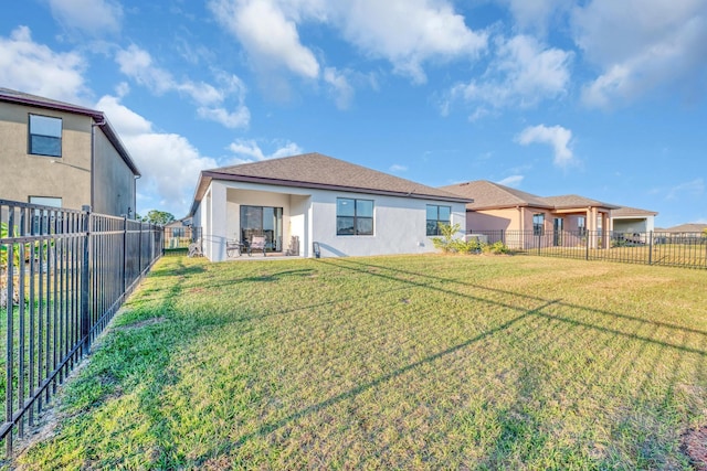 back of house with a yard