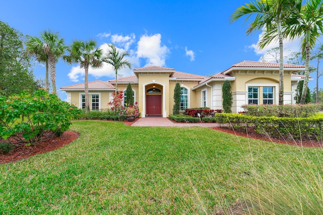 mediterranean / spanish-style home with a front yard