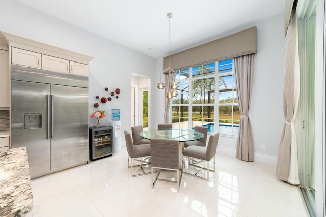 dining room featuring light tile patterned floors and wine cooler