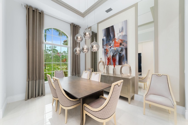 tiled dining room featuring a towering ceiling