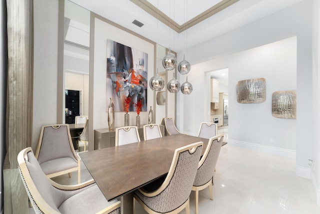 dining space with a towering ceiling and light tile patterned floors