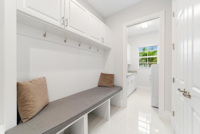 mudroom featuring light tile patterned floors and washer / dryer