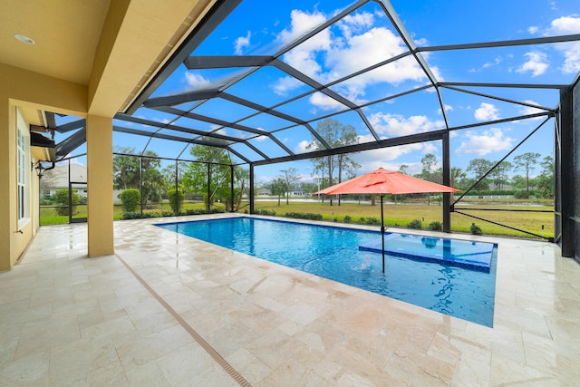 view of pool with glass enclosure, a yard, and a patio area