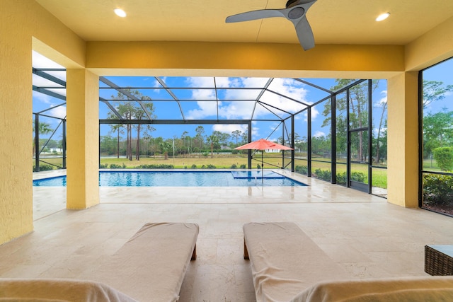 view of swimming pool featuring a patio area, a lanai, and ceiling fan