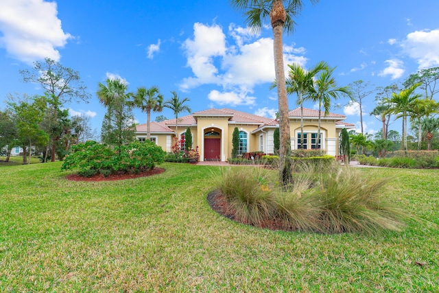 mediterranean / spanish home with a front yard