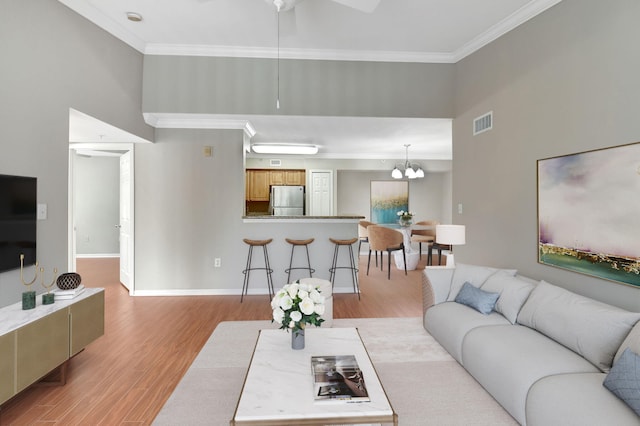 15155 Michelangelo Blvd Unit 201, Delray Beach, FL 33446 - living area with baseboards, light wood-style flooring, visible vents, and crown molding