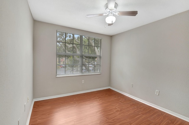 unfurnished room with ceiling fan and wood-type flooring