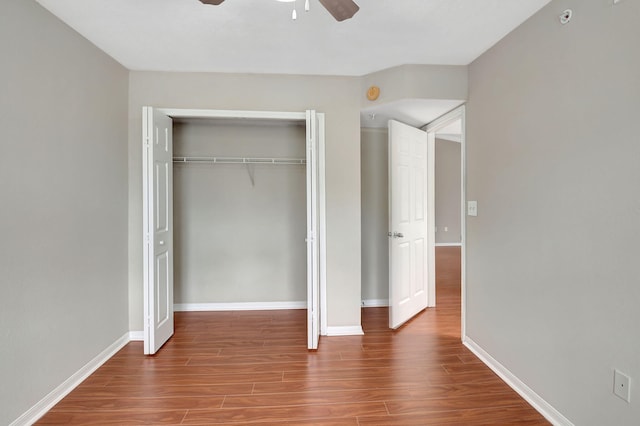 15155 Michelangelo Blvd Unit 201, Delray Beach, FL 33446 - unfurnished bedroom featuring baseboards, a ceiling fan, wood finished floors, and a closet