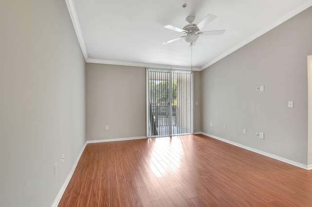 spare room featuring ceiling fan, crown molding, and wood-type flooring