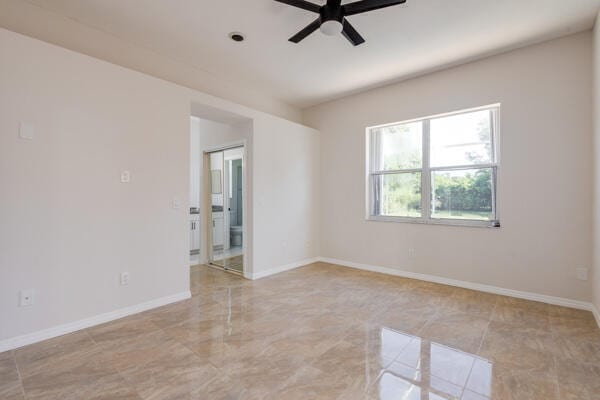 spare room with ceiling fan