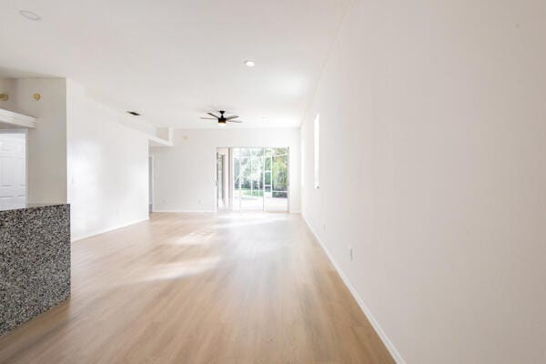 spare room with ceiling fan and light hardwood / wood-style flooring