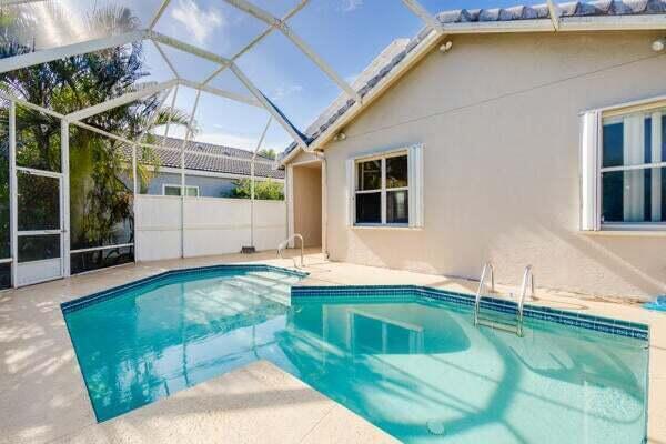 view of swimming pool featuring a lanai