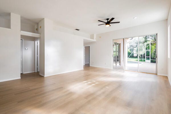 spare room featuring wood-type flooring and ceiling fan