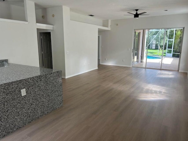 unfurnished living room featuring ceiling fan and wood-type flooring